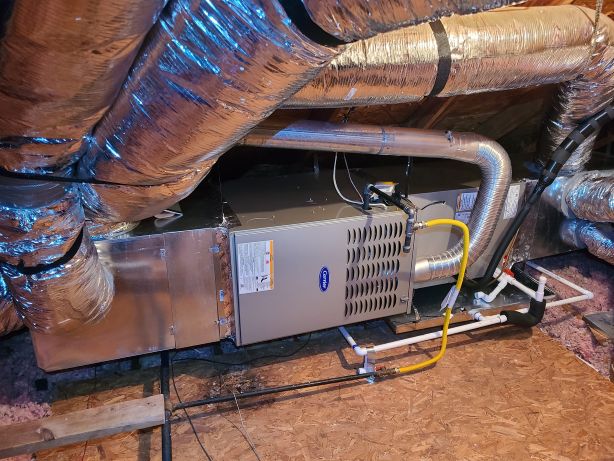 Image of a gas furnace setup, featuring Comfort Conditioning and highlighting the professional installation of a Carrier gas furnace system.