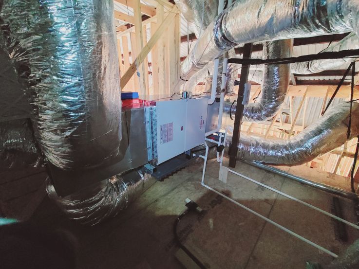 Image of an air conditioning unit, featuring Comfort Conditioning and highlighting AC installation with concrete pads and wired setup for stable and secure operation.