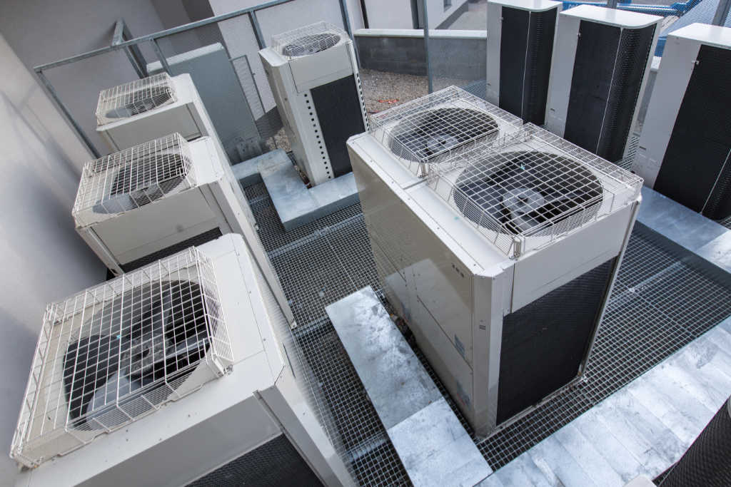 Image of an air conditioning unit, featuring Comfort Conditioning and highlighting AC installation with concrete pads and wired setup for stable and secure operation.