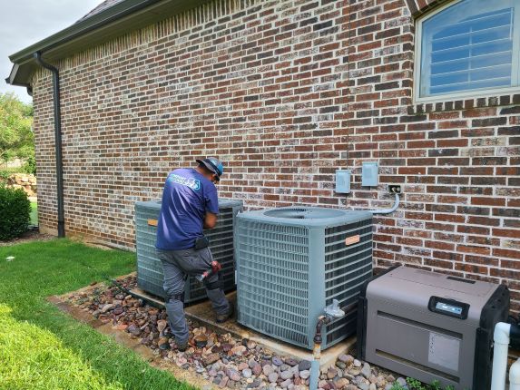 Image of a technician working in a side yard with a generator visible, featuring Comfort Conditioning and highlighting an HVAC tech session and side yard setup.