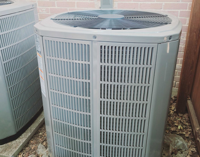Image of an American Standard outdoor air conditioning unit installed beside a home, featuring Comfort Conditioning and highlighting the company’s professional HVAC services available on their website.