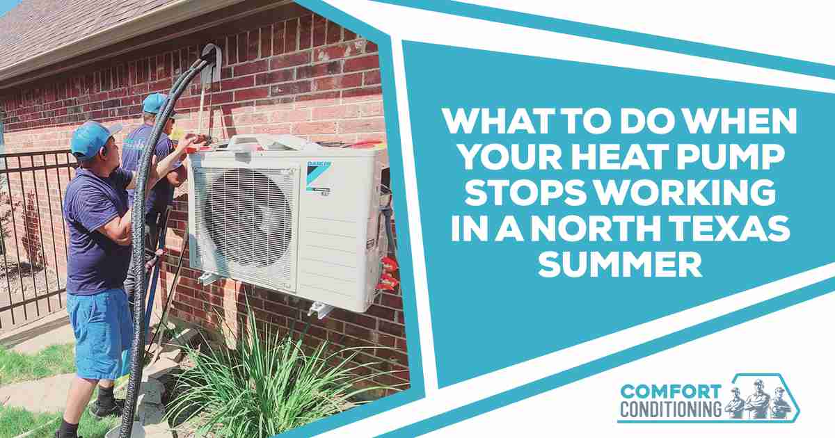 HVAC technician servicing an outdoor heat pump unit beside a residential home