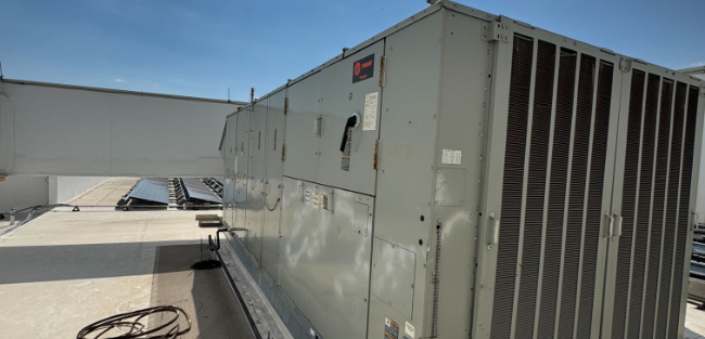 Image of a rooftop HVAC unit with clear blue sky background, featuring Comfort Conditioning, highlighting the company’s professional heating and cooling services offered on their website.